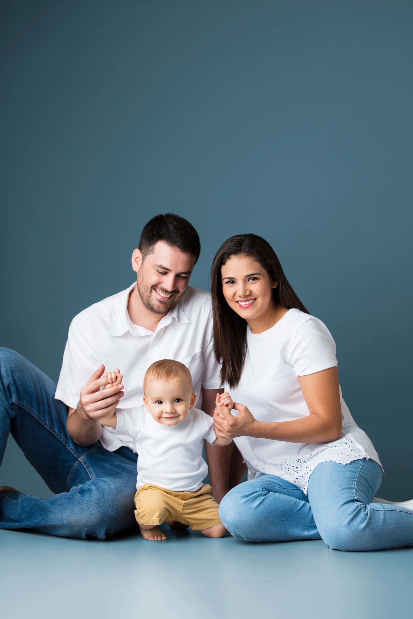 Parents holding a baby and smiling