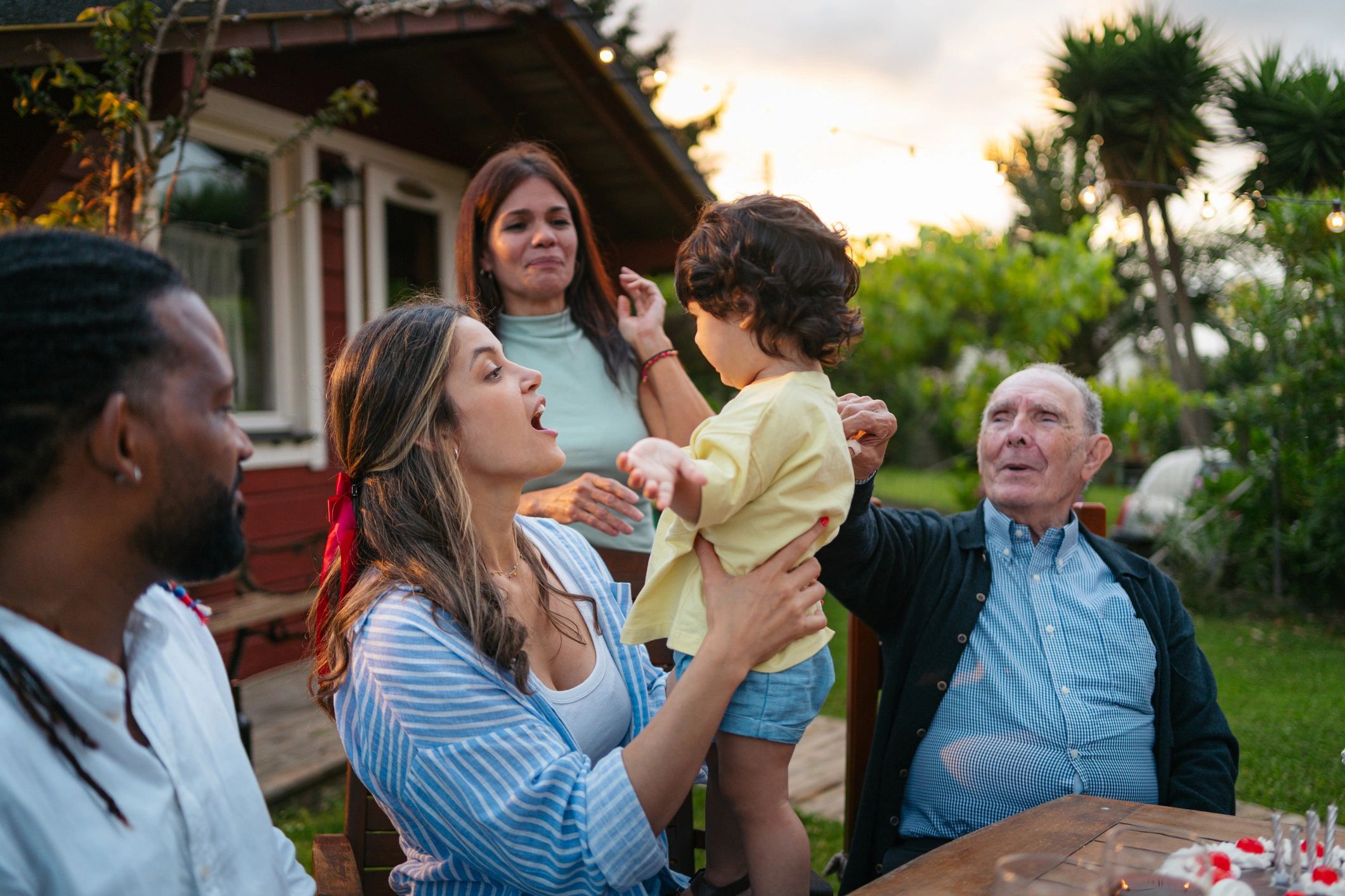 Multi-generational family gathering outdoors together