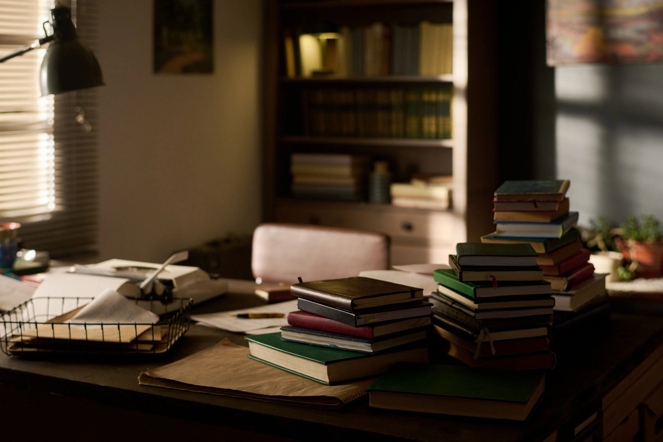 Stack of books and research materials on a desk