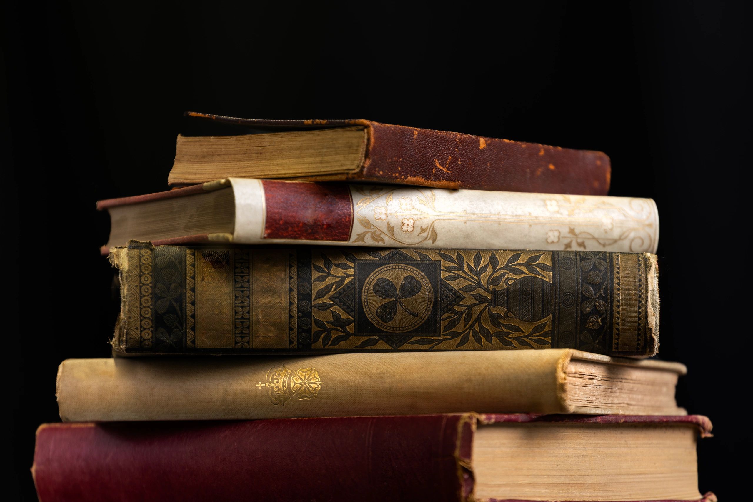 Stack of antique books representing family records and history